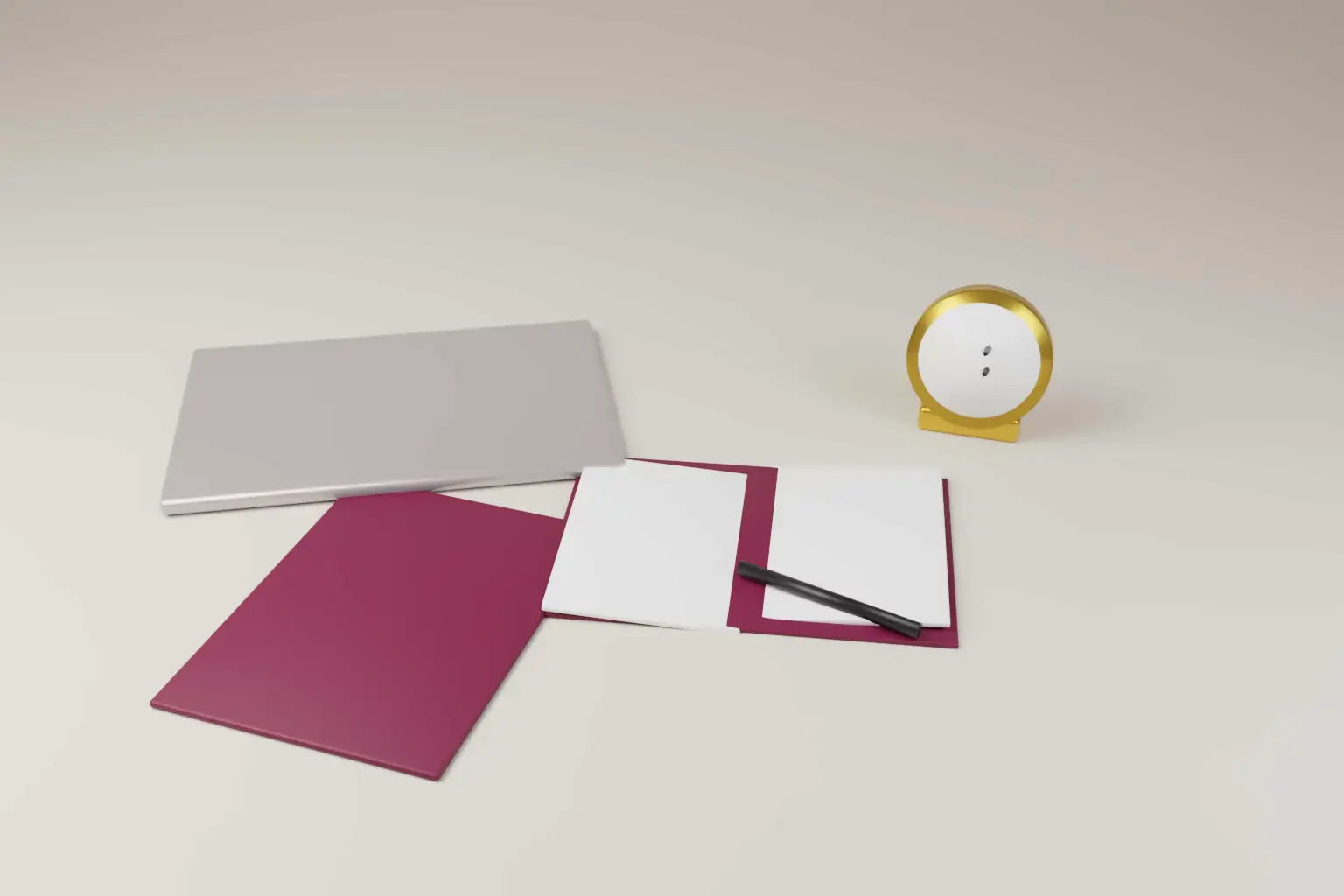 An open notebook with blank pages, a closed laptop, a wine coloured folder and a small gold desk clock on a pale desk.